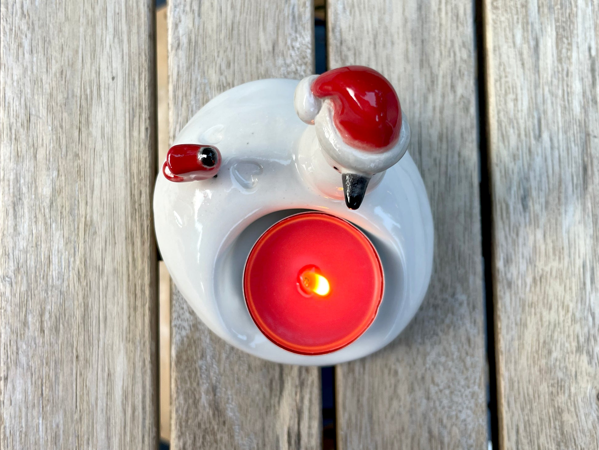 Side view of handmade snowman candle holder — cozy winter table decor.