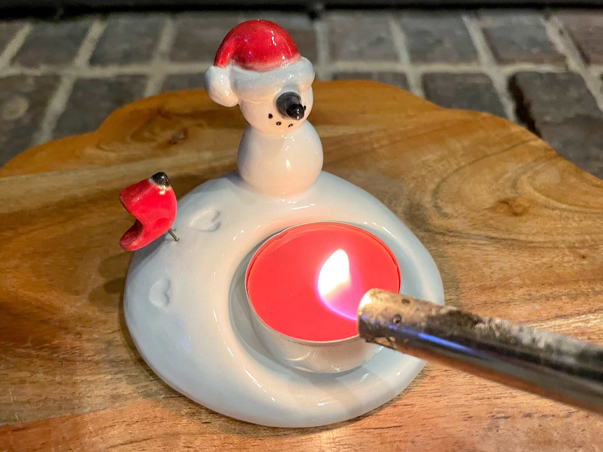 Decorative candle holder. Handmade ceramic tea light candle holder with snowman and red cardinal bird.