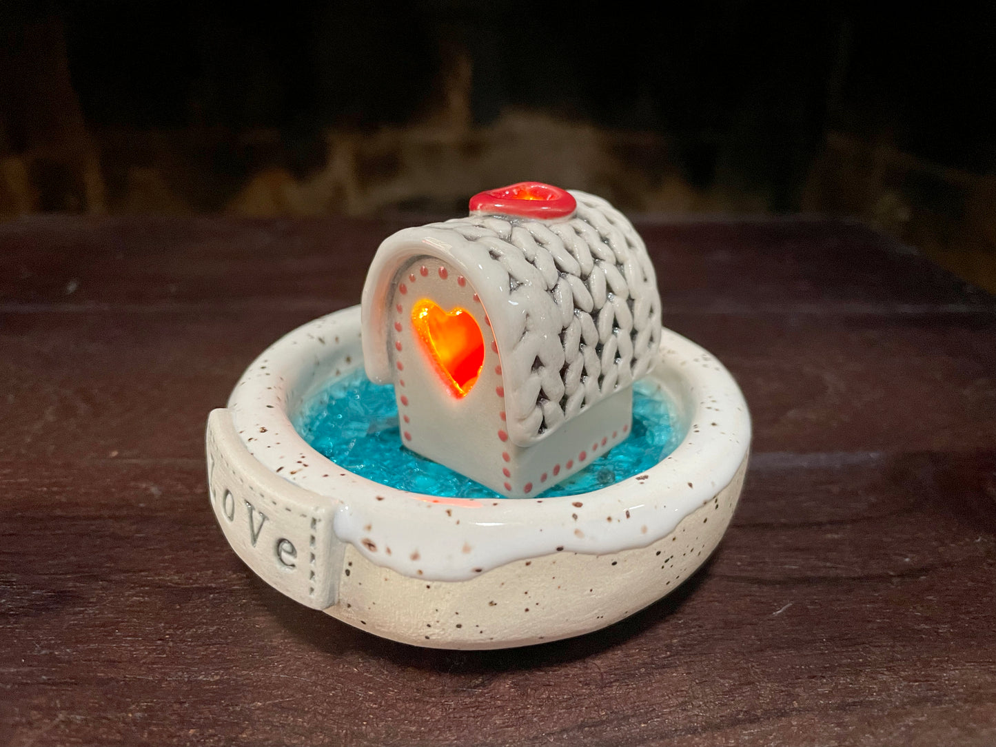 Handmade ceramic Christmas cabin set with a frozen lake incense burner and LED light. Cozy winter décor perfect for holiday displays or gifting.