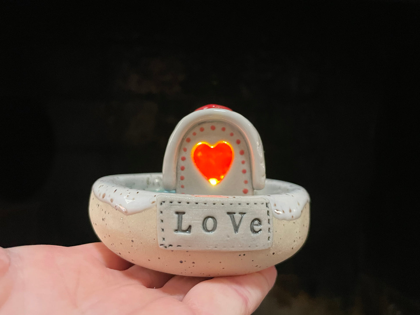 Mini ceramic cabin house with LED light and incense smoke drifting over a tiny frozen lake.