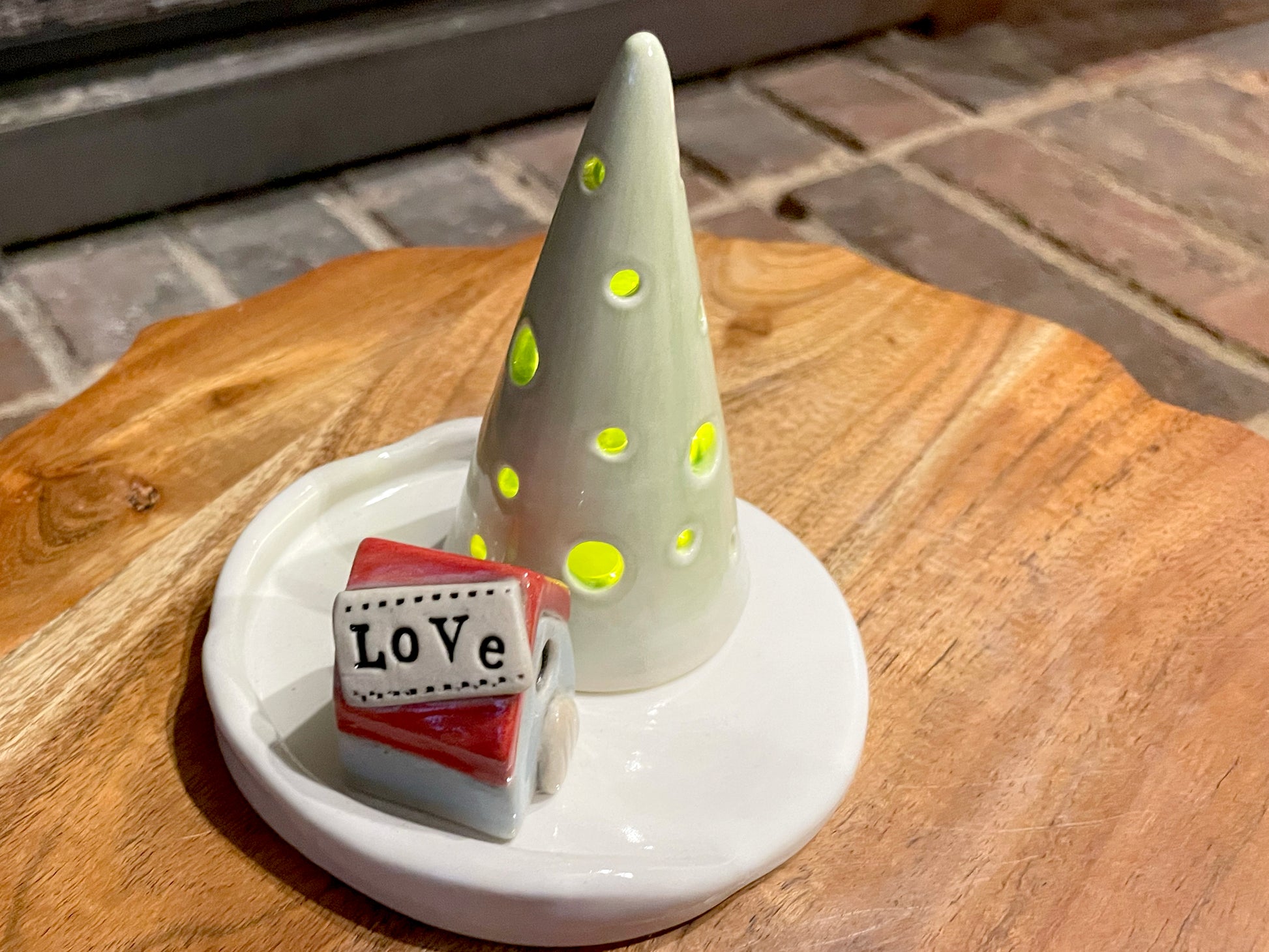 Ceramic mini village displayed as cozy holiday mantel décor with warm LED lighting