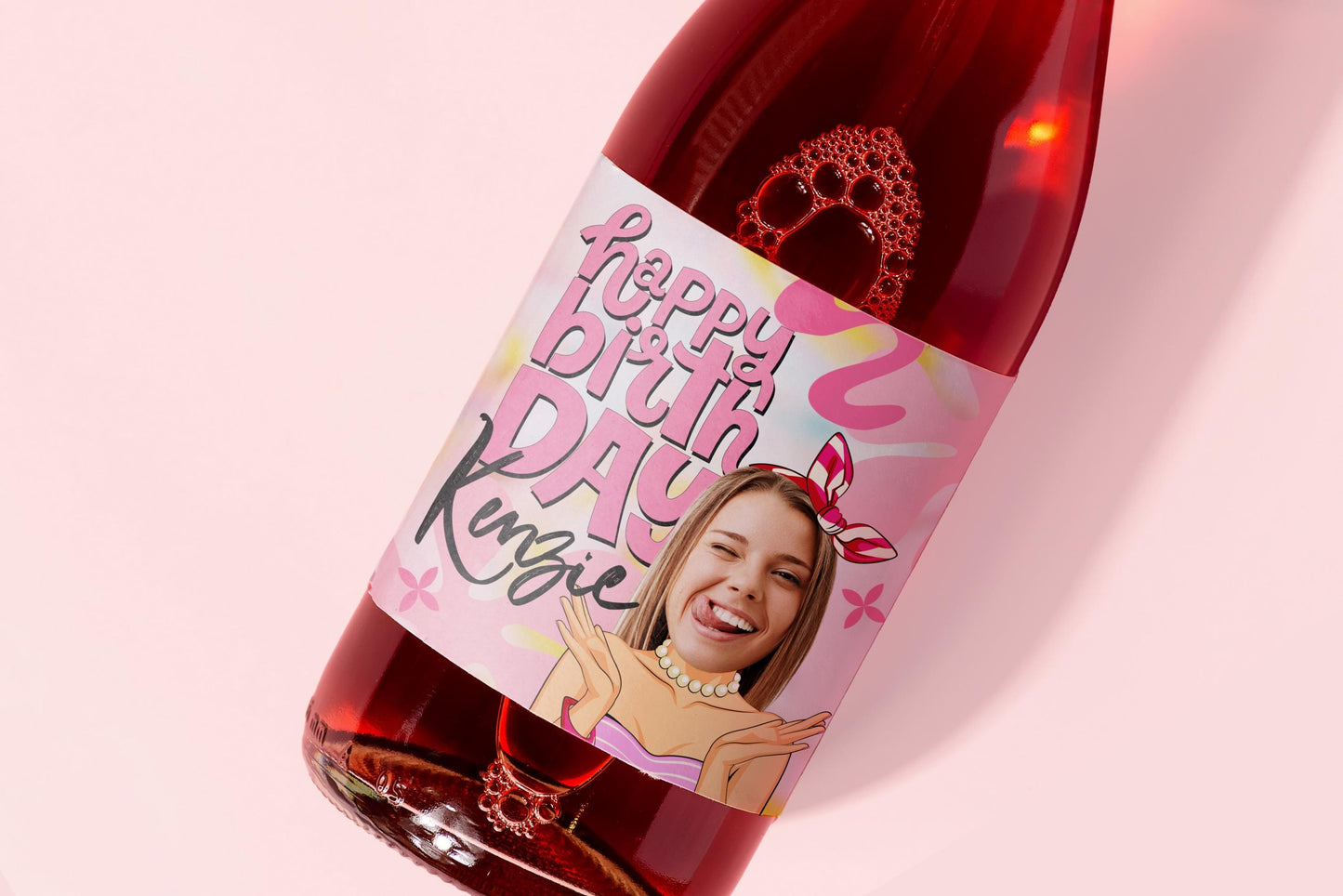 Custom wine or champagne Bottle pink label  with a personalized label featuring a smiling woman's face on a pink background